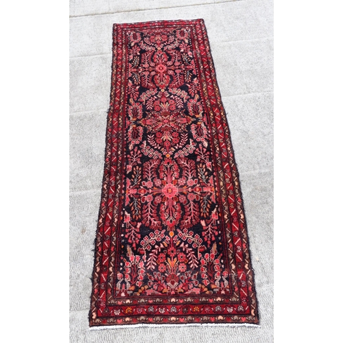 48 - A Persian hand knotted Arak runner with stylised floral design within floral guard borders, on a nav... 