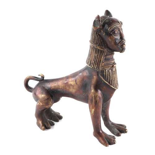 495 - An Egyptian bronze figure depicting a sphinx with stylised human head on a lions body, 17cms long.