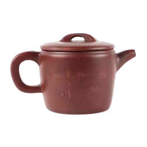 505 - A Chinese Yixing pottery teapot decorated with bamboo and calligraphy, impressed seal mark to the un... 