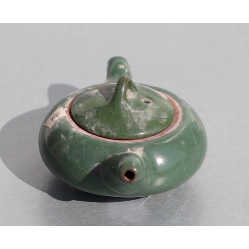 508 - A Chinese monochrome green glazed pottery teapot of compressed globular form, 14cms long.