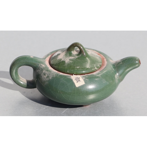 508 - A Chinese monochrome green glazed pottery teapot of compressed globular form, 14cms long.