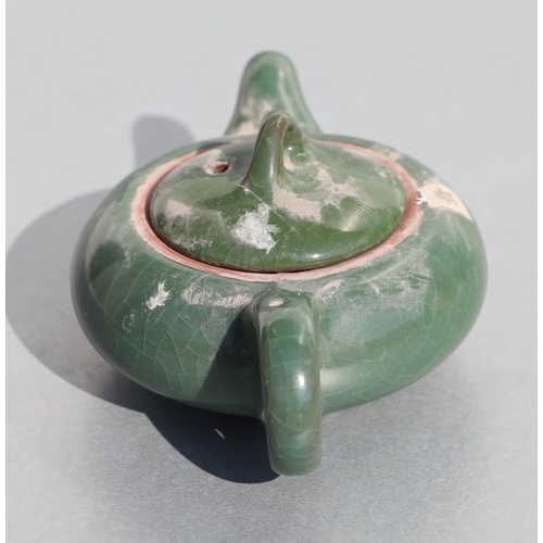 508 - A Chinese monochrome green glazed pottery teapot of compressed globular form, 14cms long.