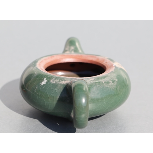 508 - A Chinese monochrome green glazed pottery teapot of compressed globular form, 14cms long.