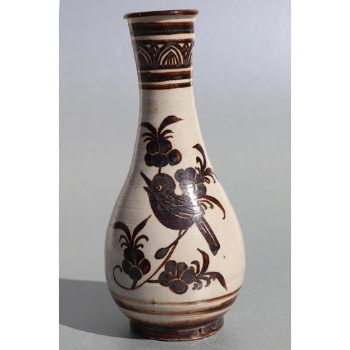 509 - A Chinese pottery baluster vase decorated with birds, 20cms high.