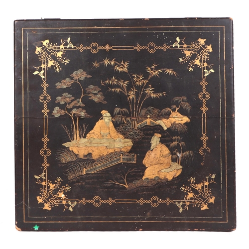 533 - A Chinese black lacquer box with gilt decoration depicting wise men within a landscape, 28cms wide; ... 