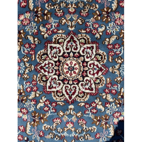 54 - A Persian Kerman hand knotted woollen rug, the central floral medallion surrounded by small sprays w... 