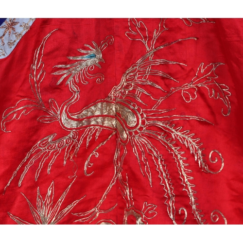 541 - A Chinese silk short jacket decorated with embroidered bullion wire phoenix and flowers, on a red gr... 