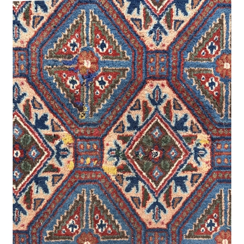 55 - A Persian Sirjan carpet with repeating blue and ivory lozenge design within a narrow repeating borde... 