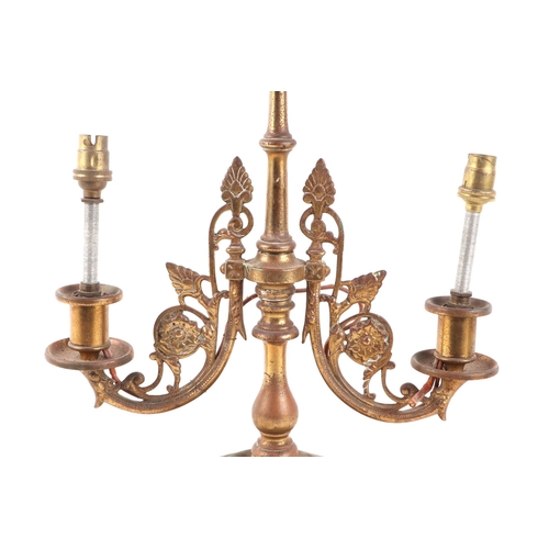 559 - A cast brass twin-arm table lamp, 23cms high.