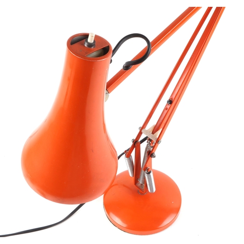 563 - A 1970's Herbert Terry model 90 Anglepoise lamp in orange; together with a pottery mid century moder... 