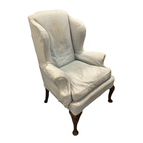 575 - A George III upholstered wing armchair with acanthus leaf carved cabriole mahogany front legs.