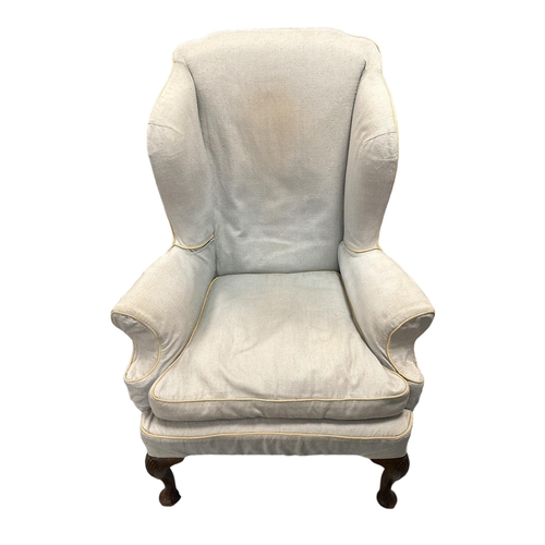 575 - A George III upholstered wing armchair with acanthus leaf carved cabriole mahogany front legs.