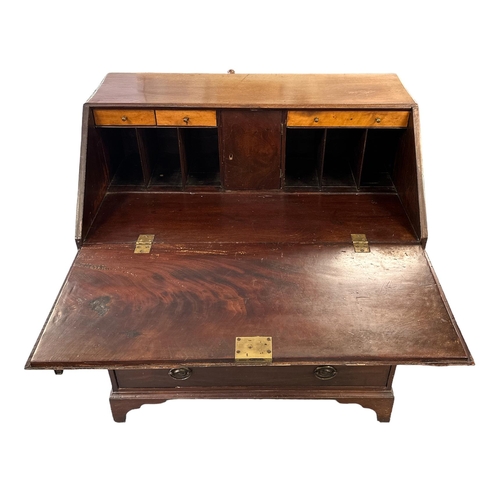 582 - A 19th century mahogany bureau, the fall-front opening to reveal a fitted interior, with maple front... 