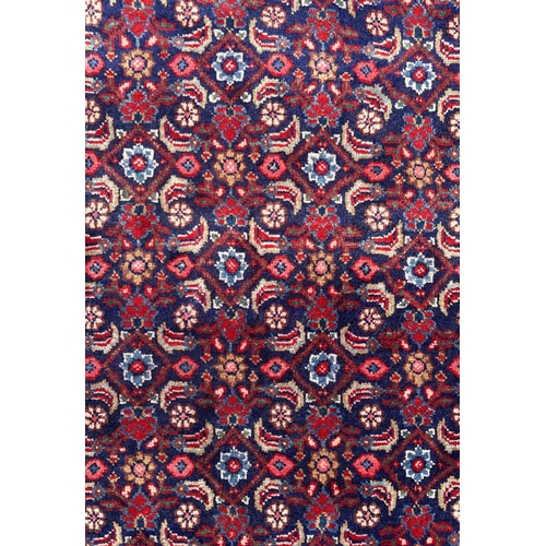 59 - A Persian Sarouk runner with repeating floral Herati design, on a blue ground, 300 by 120cms.