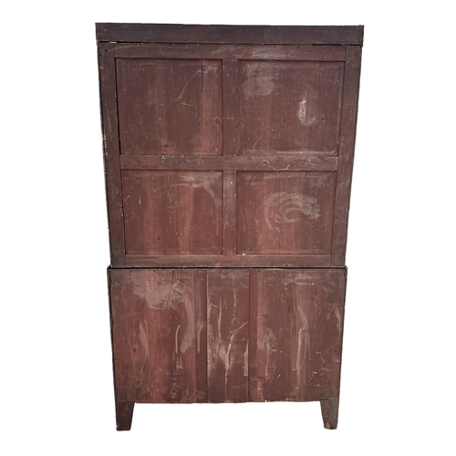 624 - An early 19th century mahogany linen press, the pair of panelled doors enclosing three linen slides ... 