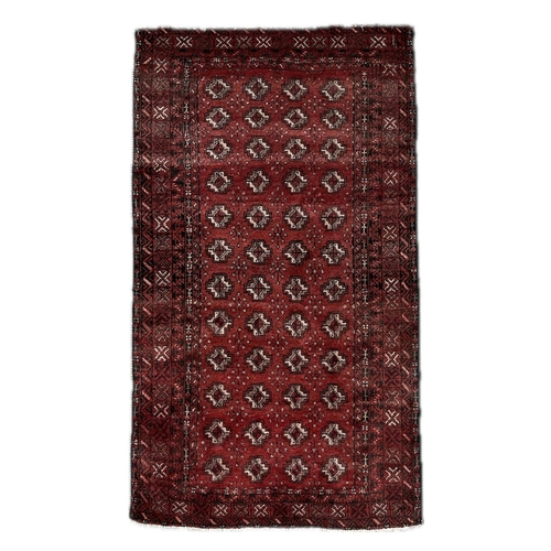 63 - A Persian Balouch rug with repeat stylised design, on a red ground, 180 by 100cms.