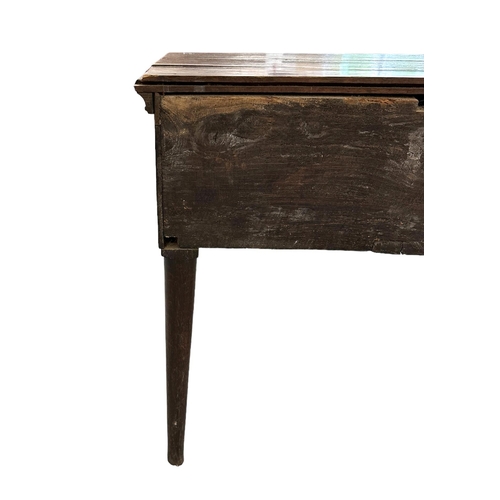 633 - An 18th century oak dresser base with three frieze drawers above a shaped apron, on cabriole front s... 