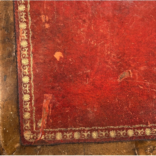 634 - A Victorian walnut library table, the rectangular top with inset red leather and two frieze drawers,... 