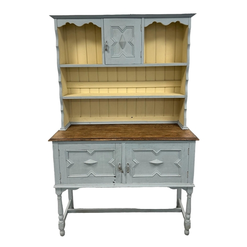 636 - An early 20th century distressed painted oak dresser, the dresser rack with central cupboard above a... 