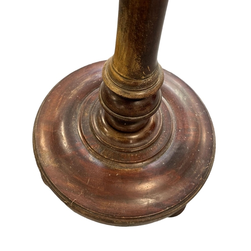 640 - A mahogany torchere on turned column and circular base, 122cms high.