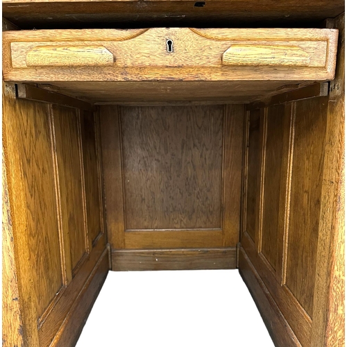 642 - An early 20th century Kenryck & Jefferson Ltd oak roll-top desk, the tambour roll-top above an arran... 