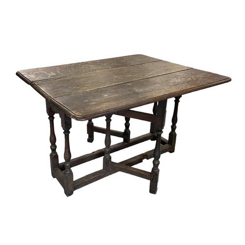 644 - A 17th / 18th century oak gateleg table, 107cms wide and 69cms high.