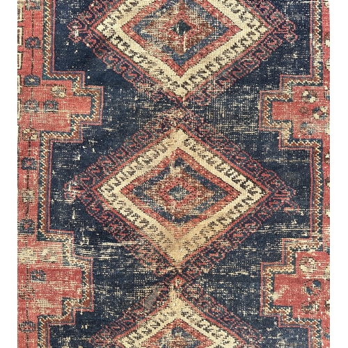 66 - A Persian hand knotted woollen rug with three central medallions within borders, on a beige ground, ... 