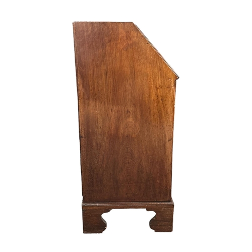 666 - A Georgian mahogany bureau, the fall-flap enclosing a shelved interior above four graduated long dra... 