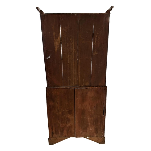 667 - An early 19th century mahogany bureau bookcase, the pair of shaped glazed doors enclosing a shelved ... 