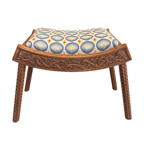 671 - An Arts & Crafts carved walnut stool with upholstered seat, the frieze carved with Celtic scrolls, 6... 