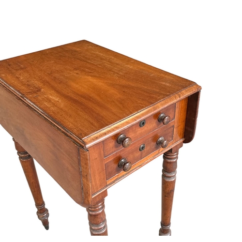 676 - A Victorian drop-leaf work table with two short drawers opposed by two faux drawers, on turned legs ... 