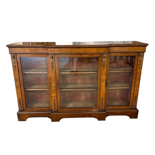 677 - A late 19th century inlaid figured walnut breakfront glazed bookcase with ormolu mounts, 168cms wide... 