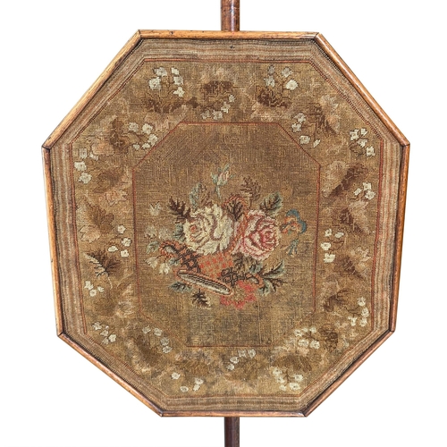 681 - A 19th century mahogany pole screen with octagonal needlework panel.