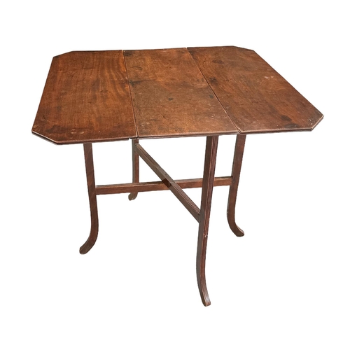 684 - A 19th century mahogany drop-leaf occasional table on reeded legs, 69cms wide.