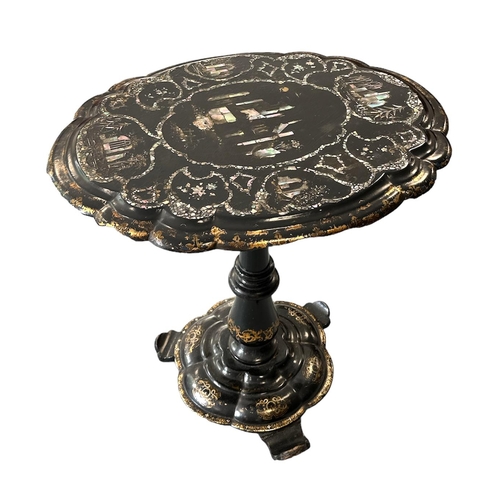 690 - A Victorian papier-mâché tilt-top occasional table inlaid with mother of pearl and having gilt highl... 