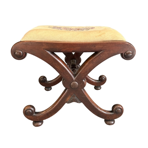 700 - A 19thc century mahogany 'X' frame stool with upholstered seat.