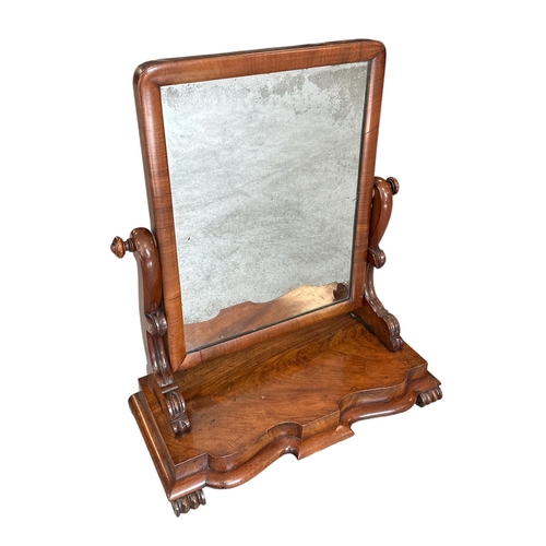 701 - A Victorian figured mahogany toilet mirror, 58cms wide together with n Arts & Crafts carved walnut o... 