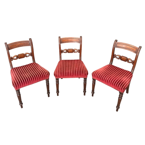 702 - A set of six Regency mahogany dining chairs with upholstered stuff-over seats, on turned front suppo... 