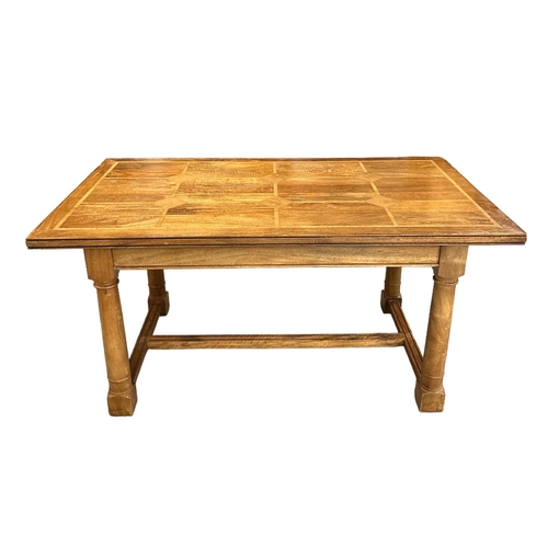 722 - A modern fruitwood extending dining table on turned legs joined by an 'H' stretcher; together with s... 