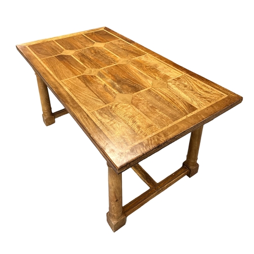 722 - A modern fruitwood extending dining table on turned legs joined by an 'H' stretcher; together with s... 