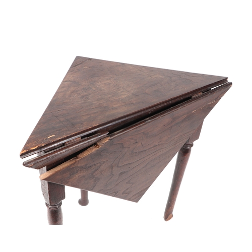 718 - A George II oak triangular drop-leaf occasional table of joint pegged construction with tapering leg... 