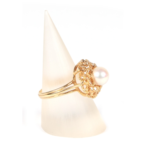 486 - An 18ct gold ring set with a central pearl, approx UK size M, 4g.