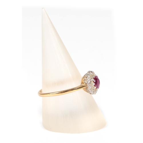 487 - An 18ct gold and platinum ruby and diamond cluster ring, approx UK size N, 2.1g.