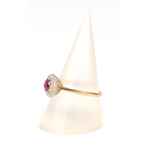 487 - An 18ct gold and platinum ruby and diamond cluster ring, approx UK size N, 2.1g.