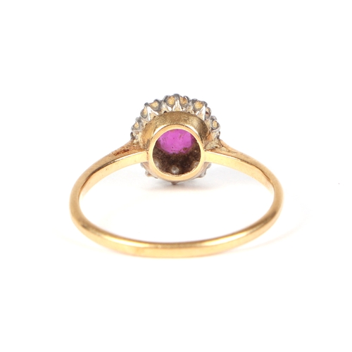 487 - An 18ct gold and platinum ruby and diamond cluster ring, approx UK size N, 2.1g.