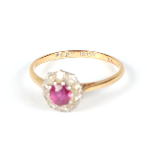 487 - An 18ct gold and platinum ruby and diamond cluster ring, approx UK size N, 2.1g.