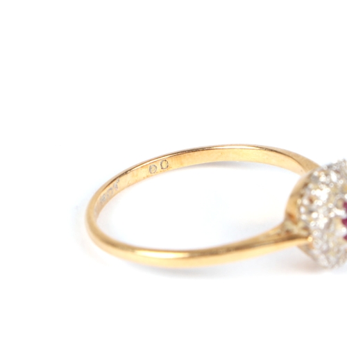 487 - An 18ct gold and platinum ruby and diamond cluster ring, approx UK size N, 2.1g.