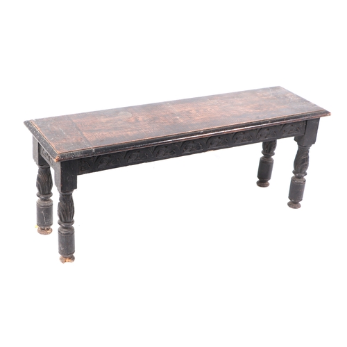 604 - A late 19th century carved oak window seat, 107cms wide.