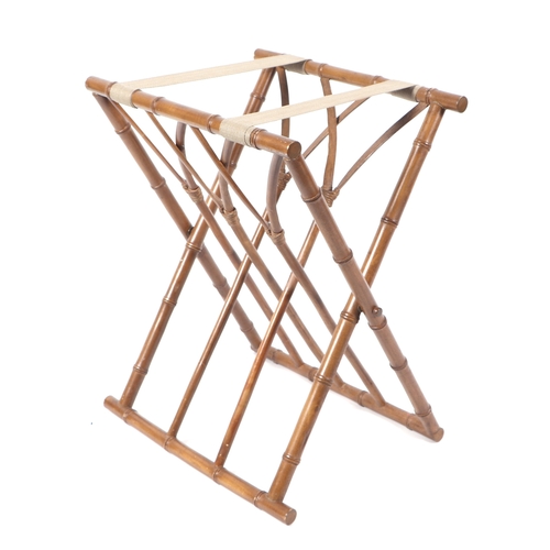 597 - A faux bamboo folding luggage rack; together with a vintage suitcase.