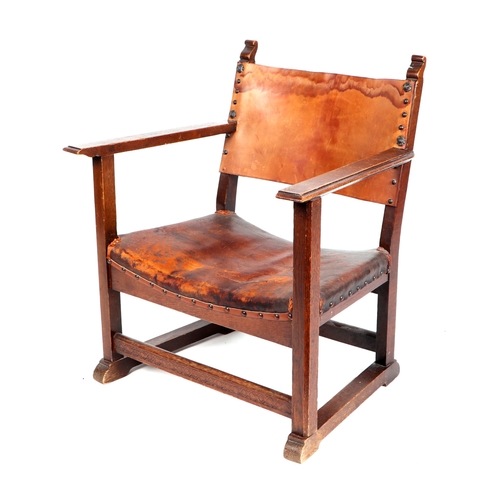 750 - An Arts & Crafts inspired stained beech child's armchair with leather back and seat.